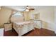 Cozy bedroom with hardwood floors, ceiling fan, and light colored walls and decor at 14564 110Th Ter, Largo, FL 33774