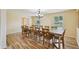 Well-lit dining room showcasing a large dining table and elegant chandelier fixture at 14564 110Th Ter, Largo, FL 33774