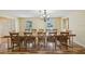Bright dining room with a long dining table set for a feast, illuminated by a decorative light at 14564 110Th Ter, Largo, FL 33774