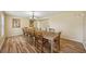 Spacious dining room featuring a long table and hardwood floors, perfect for entertaining guests at 14564 110Th Ter, Largo, FL 33774