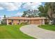Charming single-story home with a well-manicured lawn and a long, winding driveway at 14564 110Th Ter, Largo, FL 33774