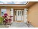 Close up of home's front door entrance with sidelights and decorative plants at 14564 110Th Ter, Largo, FL 33774