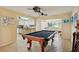 Inviting game room with a pool table, seamlessly connected to the kitchen and living room at 14564 110Th Ter, Largo, FL 33774
