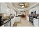 Modern kitchen with black countertops, stainless steel appliances and views into the game room at 14564 110Th Ter, Largo, FL 33774