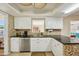 Updated kitchen features black countertops, stylish backsplash and stainless steel appliances at 14564 110Th Ter, Largo, FL 33774