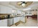 Modern kitchen featuring granite countertops, tile backsplash, and views of the adjacent billiards room at 14564 110Th Ter, Largo, FL 33774