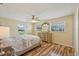 A serene main bedroom featuring wood floors and a decorative dresser with matching mirror at 14564 110Th Ter, Largo, FL 33774