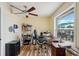 Bright home office with ceiling fan, wood floors and large window views of outdoor patio at 14564 110Th Ter, Largo, FL 33774