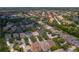 Aerial view of a residential area with well-maintained homes, lush landscaping, and a serene lake in the distance at 14610 Mondavi Ct, Tampa, FL 33626