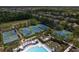 Aerial view showcasing a community's recreational facilities, including tennis and basketball courts, set among green spaces at 14610 Mondavi Ct, Tampa, FL 33626