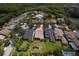 Located in a tranquil neighborhood, this home boasts a manicured lawn, screened lanai, and lush landscaping, as seen from above at 14610 Mondavi Ct, Tampa, FL 33626