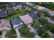 From above, see a charming home with a paved driveway nestled among mature trees in a well-maintained neighborhood at 14610 Mondavi Ct, Tampa, FL 33626