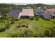An overhead shot shows a home's spacious backyard, complete with lush lawn and privacy landscaping at 14610 Mondavi Ct, Tampa, FL 33626