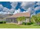 A well-maintained backyard with a screened lanai and palm trees create a tropical oasis at 14610 Mondavi Ct, Tampa, FL 33626