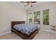 Bedroom featuring a ceiling fan, tile floors, and natural light at 14610 Mondavi Ct, Tampa, FL 33626