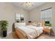 Neutral bedroom with a queen bed, matching nightstands and natural sunlight at 14610 Mondavi Ct, Tampa, FL 33626