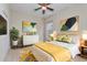 Stylish bedroom featuring a queen bed, accent art, and bright yellow accents at 14610 Mondavi Ct, Tampa, FL 33626