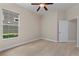 Bright bedroom with ceiling fan and large window overlooking lush greenery at 14610 Mondavi Ct, Tampa, FL 33626