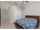 Bedroom with a ceiling fan and a view of a hallway and closet at 14610 Mondavi Ct, Tampa, FL 33626