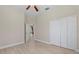 Neutral bedroom featuring modern flooring, ceiling fan, and closet storage at 14610 Mondavi Ct, Tampa, FL 33626