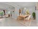 Beautifully staged dining area showcases modern table, chairs, with an open view to kitchen and living room at 14610 Mondavi Ct, Tampa, FL 33626