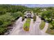 Inviting aerial view of the gated community entrance with manicured landscaping, flowerbeds, and a well-maintained roadway at 14610 Mondavi Ct, Tampa, FL 33626