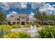 Beautiful building featuring manicured grounds, fountain and pergola, nestled among mature landscaping at 14610 Mondavi Ct, Tampa, FL 33626