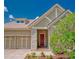 Inviting entryway with a red front door, stone accents, and a well-landscaped garden at 14610 Mondavi Ct, Tampa, FL 33626
