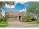 Charming home with a well-manicured front yard, brick driveway, and a convenient two-car garage at 14610 Mondavi Ct, Tampa, FL 33626