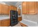 Close-up view of the kitchen with modern appliances, stone countertops, and ample cabinet space at 14610 Mondavi Ct, Tampa, FL 33626