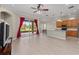 Open-concept kitchen and living area with a breakfast bar, hardwood floors, and sliding glass doors at 14610 Mondavi Ct, Tampa, FL 33626