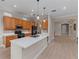 Modern kitchen featuring an island with a sink, stainless steel appliances, and ample cabinet space at 14610 Mondavi Ct, Tampa, FL 33626