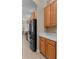 Modern kitchen features stainless steel appliances, light wood cabinetry, and light countertops at 14610 Mondavi Ct, Tampa, FL 33626
