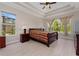 Comfortable main bedroom with large windows and tray ceiling at 14610 Mondavi Ct, Tampa, FL 33626