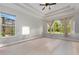 Airy main bedroom with tray ceilings and large windows showcasing the verdant yard at 14610 Mondavi Ct, Tampa, FL 33626
