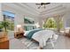Cozy main bedroom featuring a queen bed, large windows and stylish decor at 14610 Mondavi Ct, Tampa, FL 33626