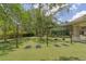 A playground featuring swings and climbing structures with shade, set in a well-maintained community space at 14610 Mondavi Ct, Tampa, FL 33626