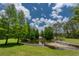 A tranquil water feature flows through the landscape, complementing a backyard pond at 14610 Mondavi Ct, Tampa, FL 33626
