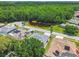 Beautiful aerial view of homes with solar panels, a pond, and lush green trees at 1521 Brittany Ct, New Port Richey, FL 34655
