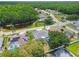 Beautiful aerial view of homes with pools and solar panels with a pond and lush green trees at 1521 Brittany Ct, New Port Richey, FL 34655