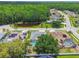 Beautiful aerial view of homes with pools and solar panels with a pond and lush green trees at 1521 Brittany Ct, New Port Richey, FL 34655