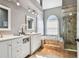 Beautiful bathroom featuring a double vanity, soaking tub, shower, and modern fixtures at 1521 Brittany Ct, New Port Richey, FL 34655