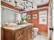 Bathroom boasts granite countertops, a decorative lighting system, and artwork at 1521 Brittany Ct, New Port Richey, FL 34655