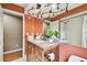 Charming bathroom with granite countertops, stylish lighting, and a view into an adjacent room at 1521 Brittany Ct, New Port Richey, FL 34655