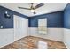 Bedroom with hardwood floors, closet, and window at 1521 Brittany Ct, New Port Richey, FL 34655