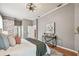 Spacious bedroom features hardwood floors, brick accent wall, contemporary lighting, and console table at 1521 Brittany Ct, New Port Richey, FL 34655