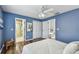 Blue bedroom with wood floors, closet, and view to bathroom and living space at 1521 Brittany Ct, New Port Richey, FL 34655