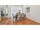 Dining area with wood floors and stylish table with seating for six at 1521 Brittany Ct, New Port Richey, FL 34655