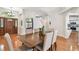 Cozy dining room featuring a chandelier, an archway, and a view into the kitchen at 1521 Brittany Ct, New Port Richey, FL 34655