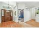 Elegant foyer featuring hardwood floors, a decorative light fixture, and an arched entrance at 1521 Brittany Ct, New Port Richey, FL 34655